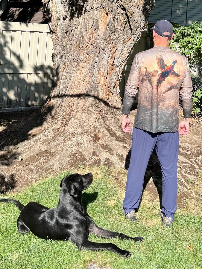 Customer wearing Golden Pheasant Flush shirt with his dog